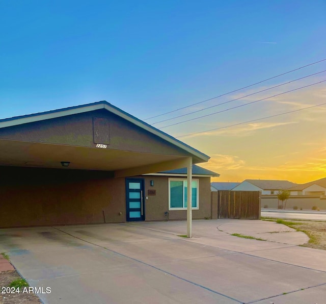 property exterior at dusk with a carport