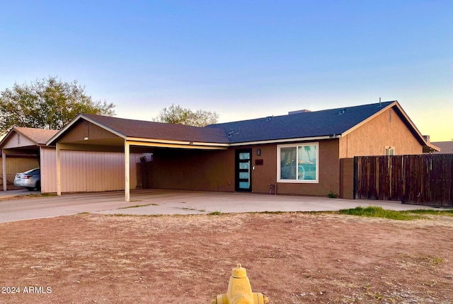 ranch-style home featuring a carport