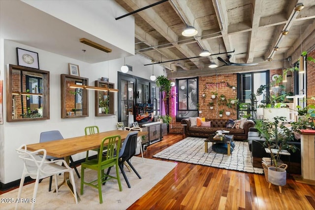 dining room with wood-type flooring and track lighting