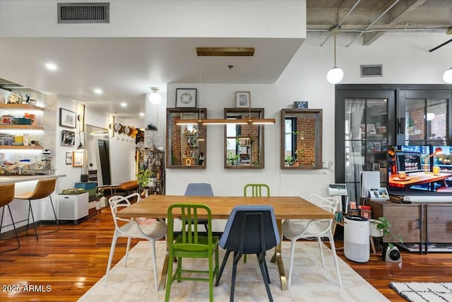 dining space with hardwood / wood-style floors