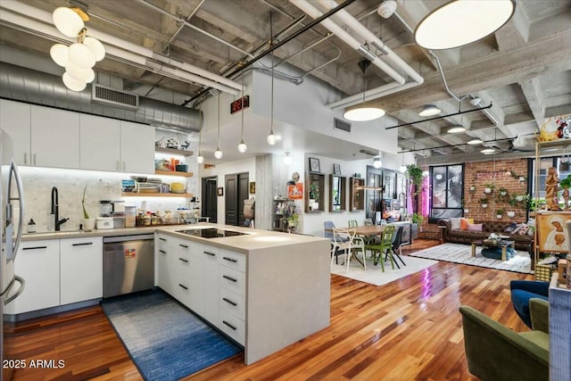 kitchen with white cabinets, dishwasher, and kitchen peninsula