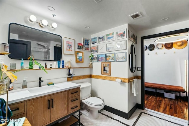 bathroom featuring toilet and vanity