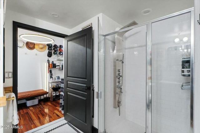 bathroom featuring wood-type flooring and walk in shower