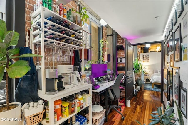 interior space featuring brick wall and wood-type flooring