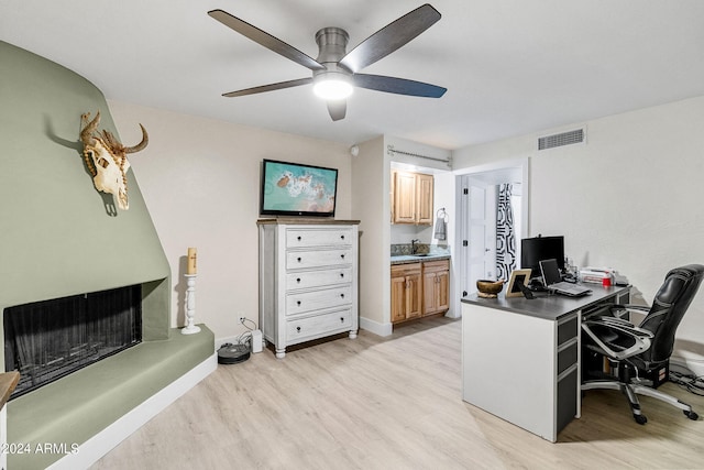 office space featuring ceiling fan and light hardwood / wood-style floors