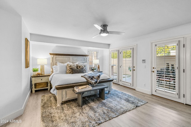 bedroom with access to exterior, light wood-type flooring, and ceiling fan