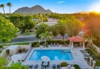 view of swimming pool featuring a mountain view, a gazebo, and a patio