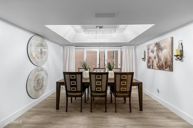 dining room with a raised ceiling