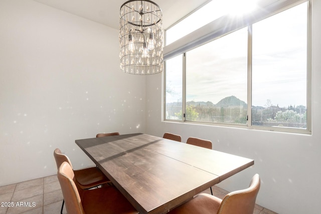 tiled dining area with a chandelier