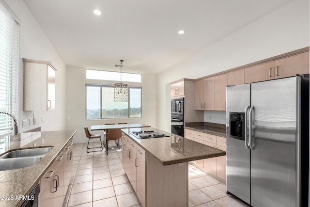 kitchen with stainless steel appliances, sink, light brown cabinets, a center island, and hanging light fixtures