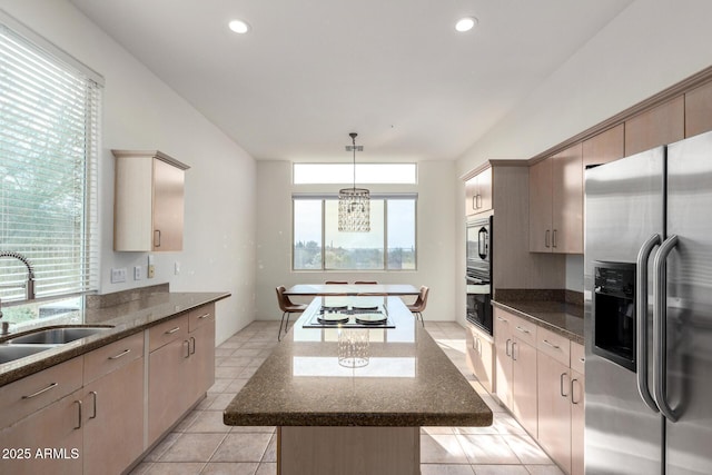 kitchen featuring pendant lighting, light brown cabinets, sink, and stainless steel appliances