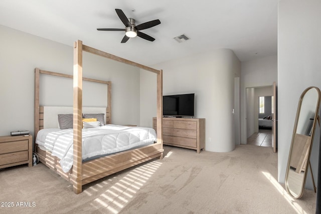 bedroom featuring ceiling fan and light carpet