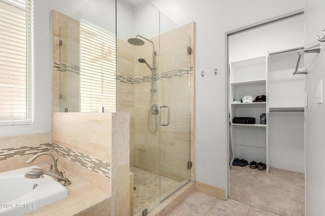 bathroom featuring tile patterned flooring, plus walk in shower, and sink