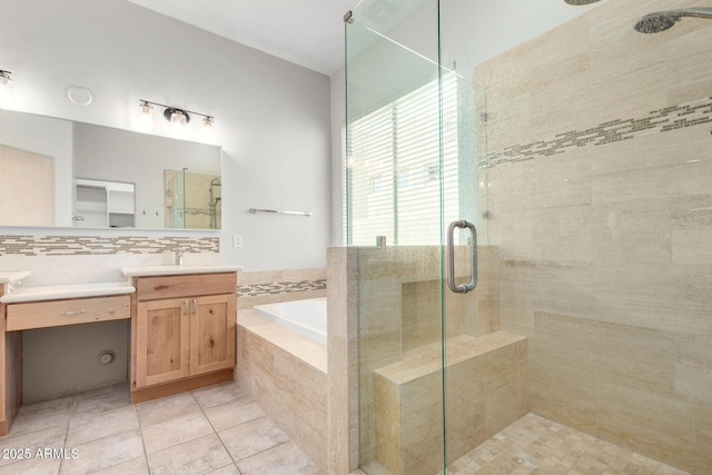 bathroom featuring tile patterned floors, tasteful backsplash, vanity, and independent shower and bath