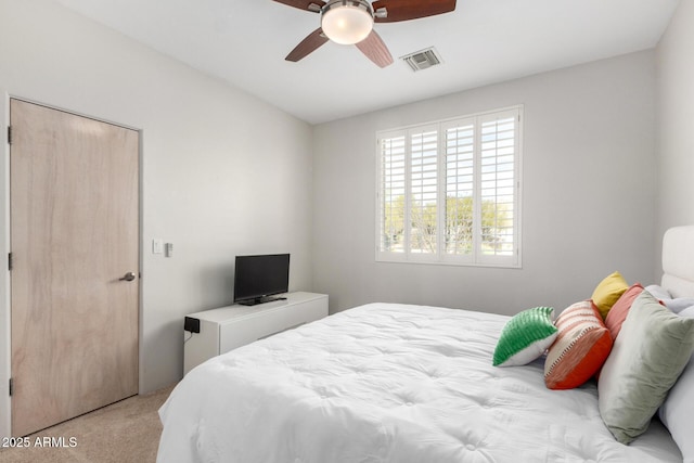 carpeted bedroom featuring a closet and ceiling fan