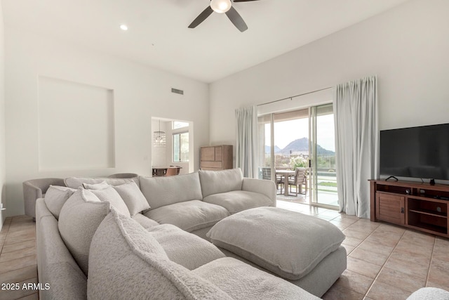 living room with ceiling fan and light tile patterned flooring