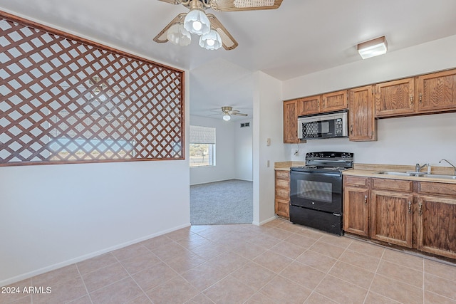 kitchen featuring ceiling fan, light tile patterned flooring, sink, and black electric range