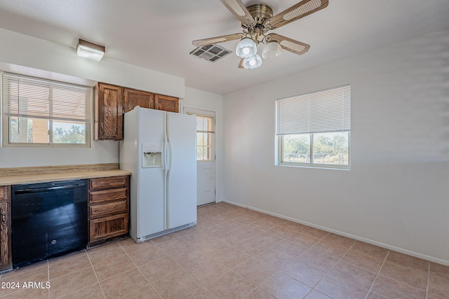 kitchen with ceiling fan, white fridge with ice dispenser, light tile patterned floors, and black dishwasher