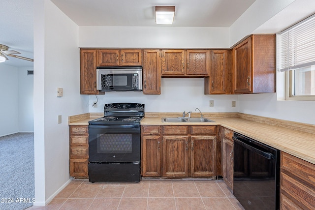 kitchen featuring ceiling fan, sink, light tile patterned floors, and black appliances