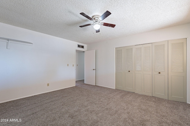 unfurnished bedroom featuring a textured ceiling, carpet floors, and ceiling fan