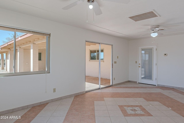 tiled empty room with ceiling fan