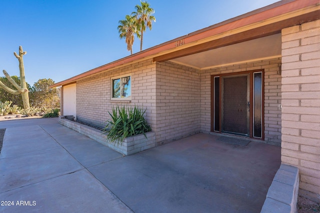 entrance to property featuring a patio area