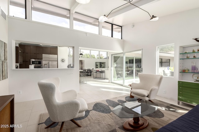tiled living room with a high ceiling and visible vents