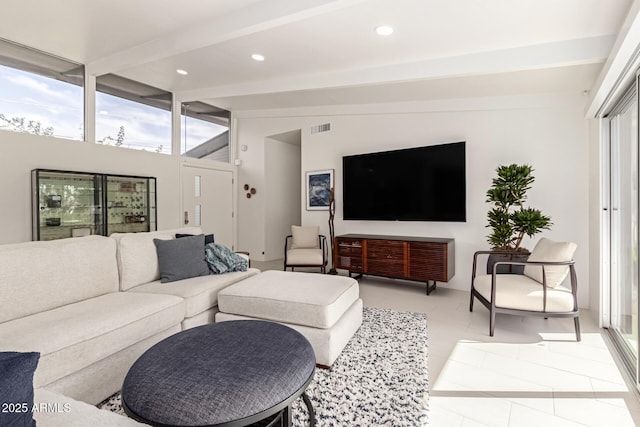 living area featuring a wealth of natural light, lofted ceiling with beams, tile patterned flooring, and recessed lighting