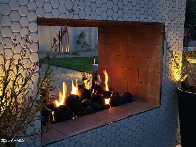 exterior details featuring a fireplace