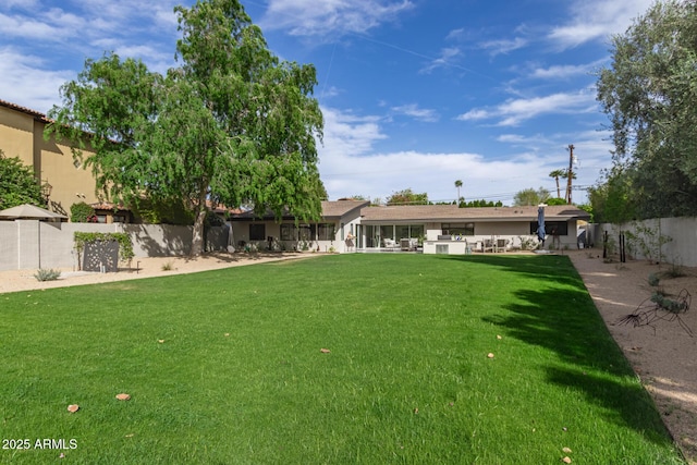 view of yard with a fenced backyard and a patio