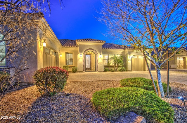 mediterranean / spanish house featuring a garage