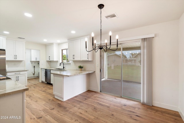 kitchen featuring sink, light hardwood / wood-style flooring, appliances with stainless steel finishes, white cabinetry, and kitchen peninsula