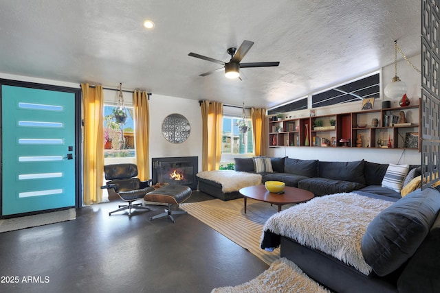 living room featuring a textured ceiling, concrete flooring, and a wealth of natural light