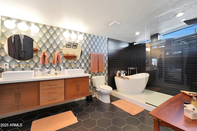 full bathroom with independent shower and bath, toilet, tile walls, tile patterned flooring, and vanity