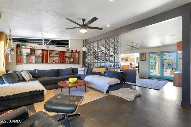 living room with concrete floors, ceiling fan, a textured ceiling, and french doors