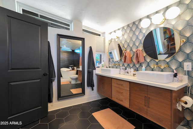 bathroom with tile patterned flooring, a bath, and vanity