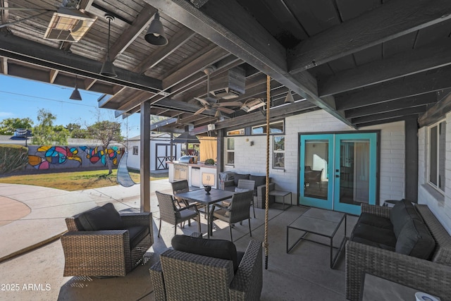 view of patio with french doors, a shed, and an outdoor hangout area