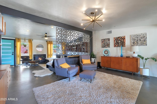 living room with ceiling fan with notable chandelier