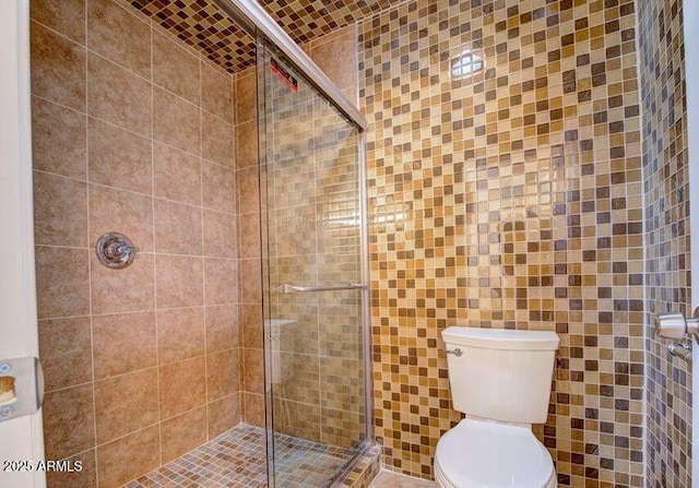 bathroom featuring walk in shower and toilet