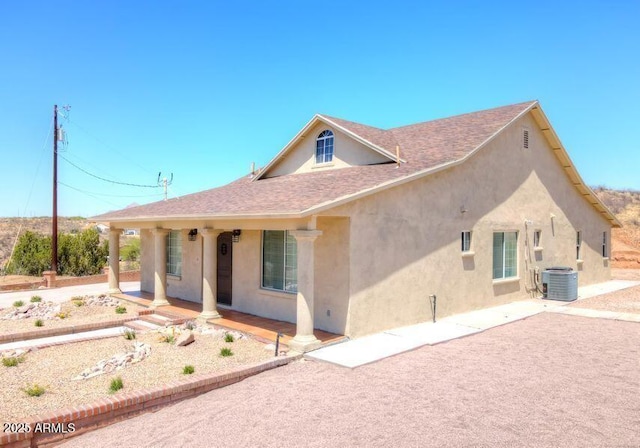 back of property with cooling unit and a porch