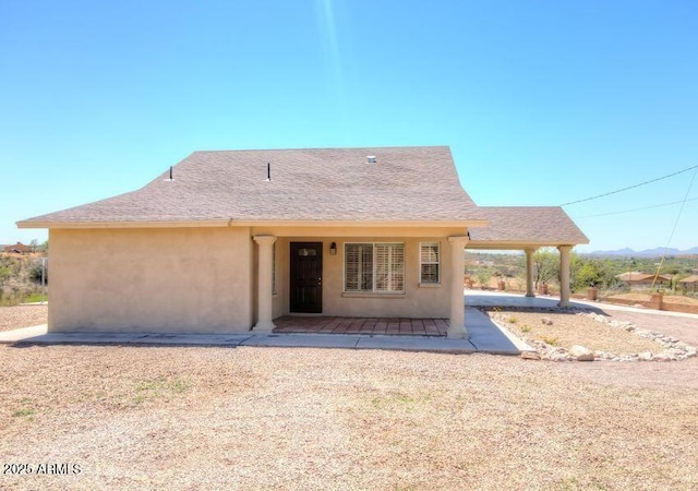 rear view of property featuring a patio area