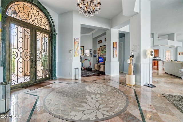 2128 E Clipper Ln, Gilbert, AZ 85234 - entrance foyer with inlaid floor details, marble tiled flooring, healthy amount of natural light, baseboards, and a high ceiling