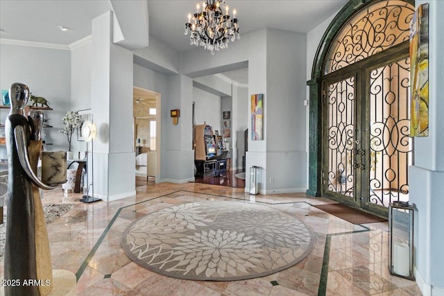 2128 E Clipper Ln, Gilbert, AZ 85234 - foyer with inlaid floor details, marble tiled flooring, baseboards, a towering ceiling, and crown molding