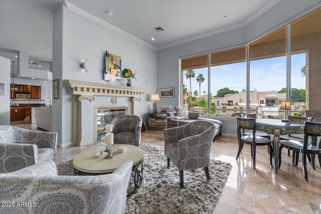 2128 E Clipper Ln, Gilbert, AZ 85234 - living area with ornamental molding, a glass covered fireplace, and light marble finish floors