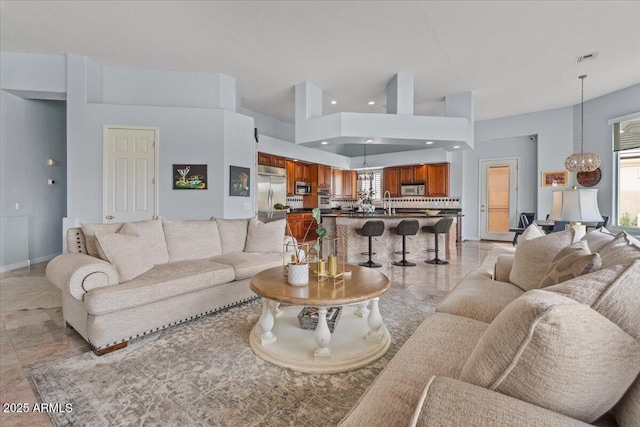 2128 E Clipper Ln, Gilbert, AZ 85234 - living room featuring a chandelier, recessed lighting, a towering ceiling, and baseboards
