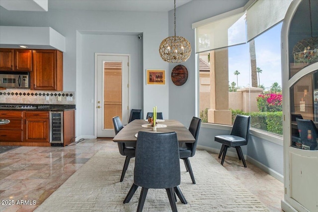 2128 E Clipper Ln, Gilbert, AZ 85234 - dining space with beverage cooler, a chandelier, and baseboards