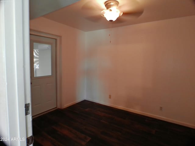 empty room featuring ceiling fan and dark hardwood / wood-style flooring