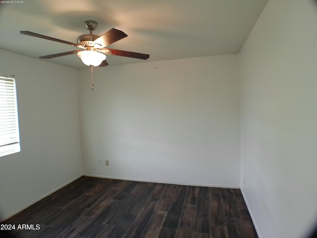 empty room with ceiling fan and dark wood-type flooring