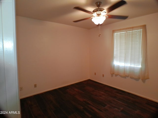 empty room featuring ceiling fan and dark wood-type flooring