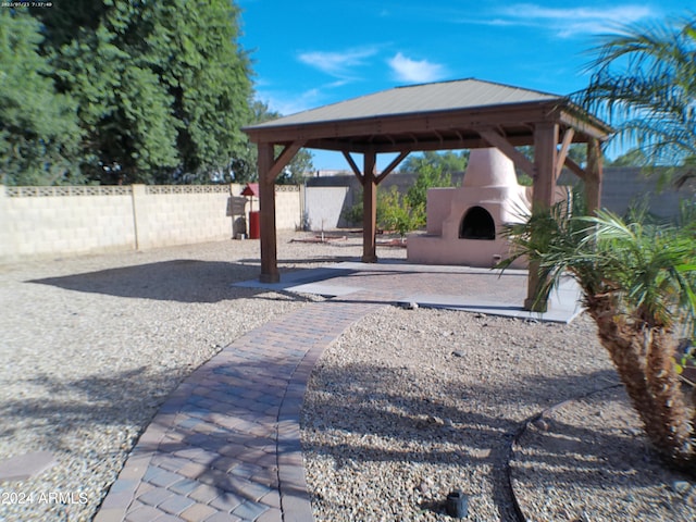 view of patio / terrace with a gazebo and an outdoor fireplace